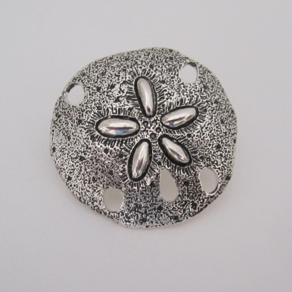 Burnished silver tone metal sand dollar pendent